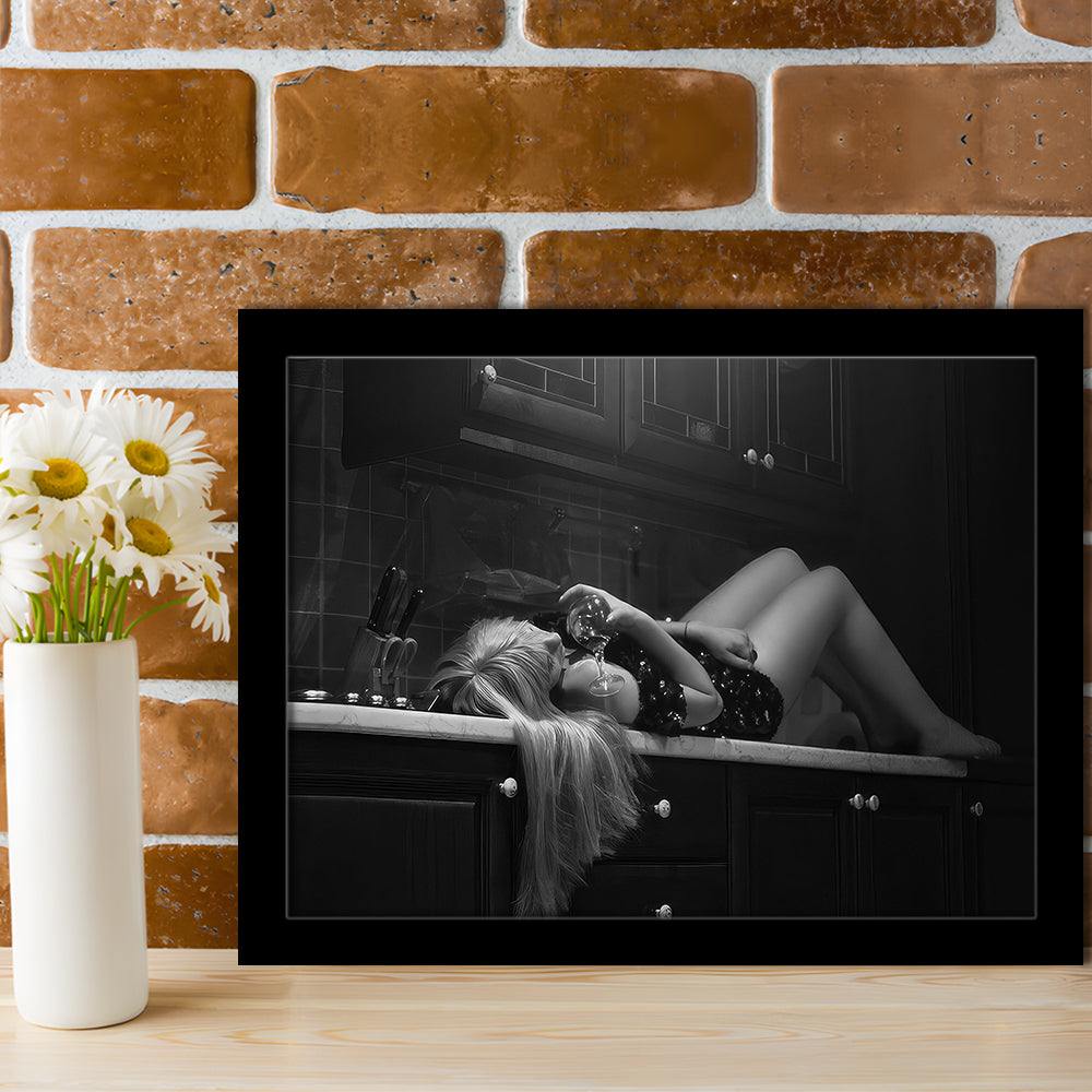 Woman Laying On Kitchen Counter Holding Wine Glass Framed Art Print Wall Decor, Drunk Woman Black and White Wall Decor
