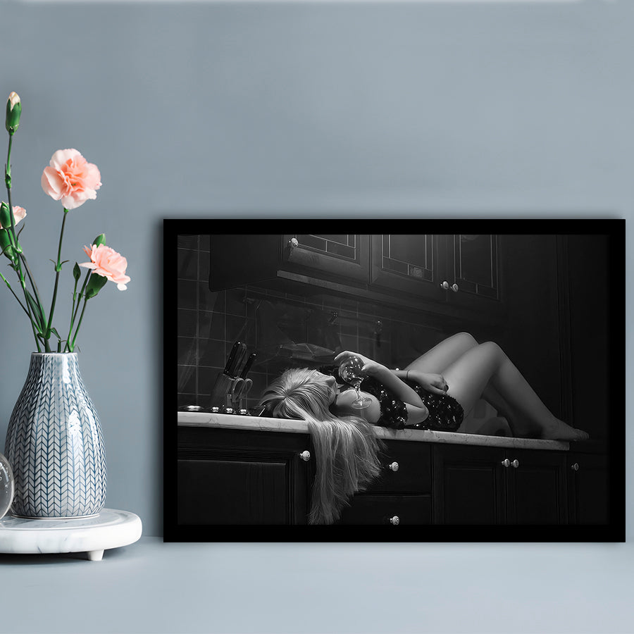 Woman Laying On Kitchen Counter Holding Wine Glass Framed Art Print Wall Decor, Drunk Woman Black and White Wall Decor
